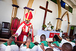 Led by Bishop Emmanuel Makala (standing), 21 new pastoral candidates are ordained in a service with more than 1,000 worshippers on Sunday, March 15, 2015, at the Evangelical Lutheran Church in Tanzania Ð South-East of Lake Victoria Diocese's (ELCT-SELVD) Ebenezer Cathedral in Shinyanga, Tanzania. LCMS Communications/Erik M. Lunsford